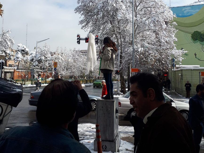 Iranian women protest obligatory headscarf by removing and 